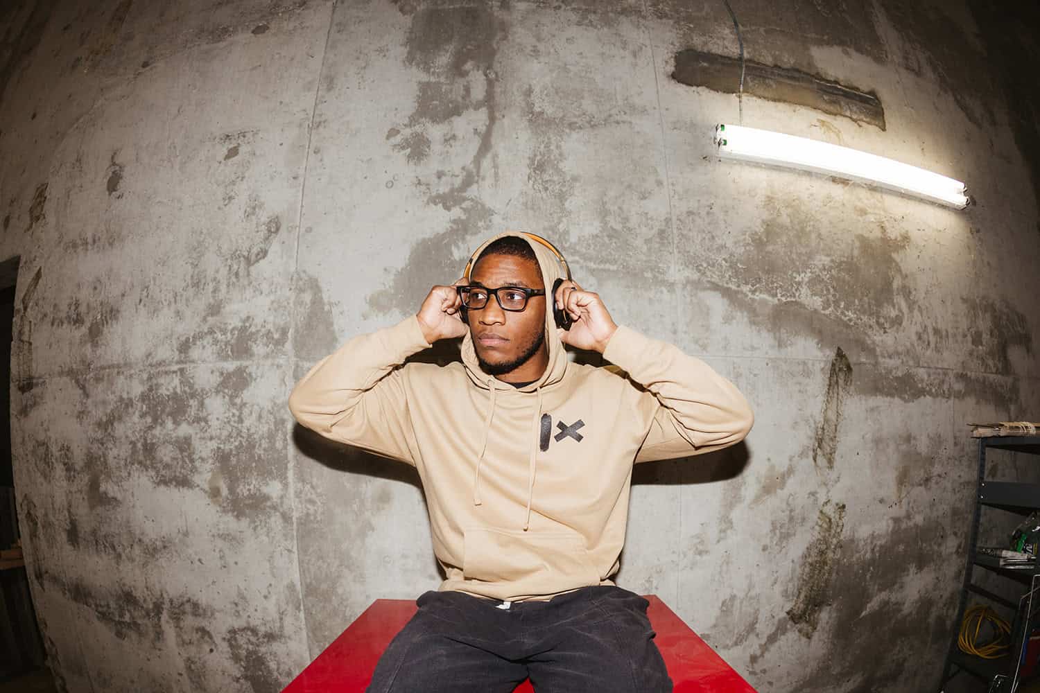 1X Ticks streetwear — hoodie design with bold graphic on concrete backdrop